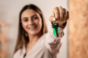 young first time homebuyer showing off new keys